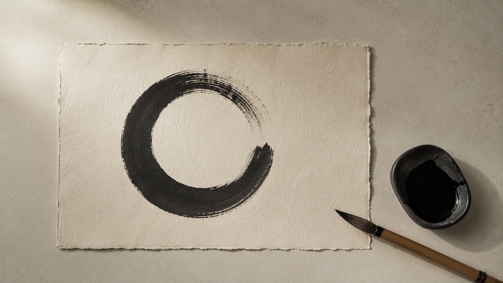 Ink brush ensō circle, representing the meditative side of the practice